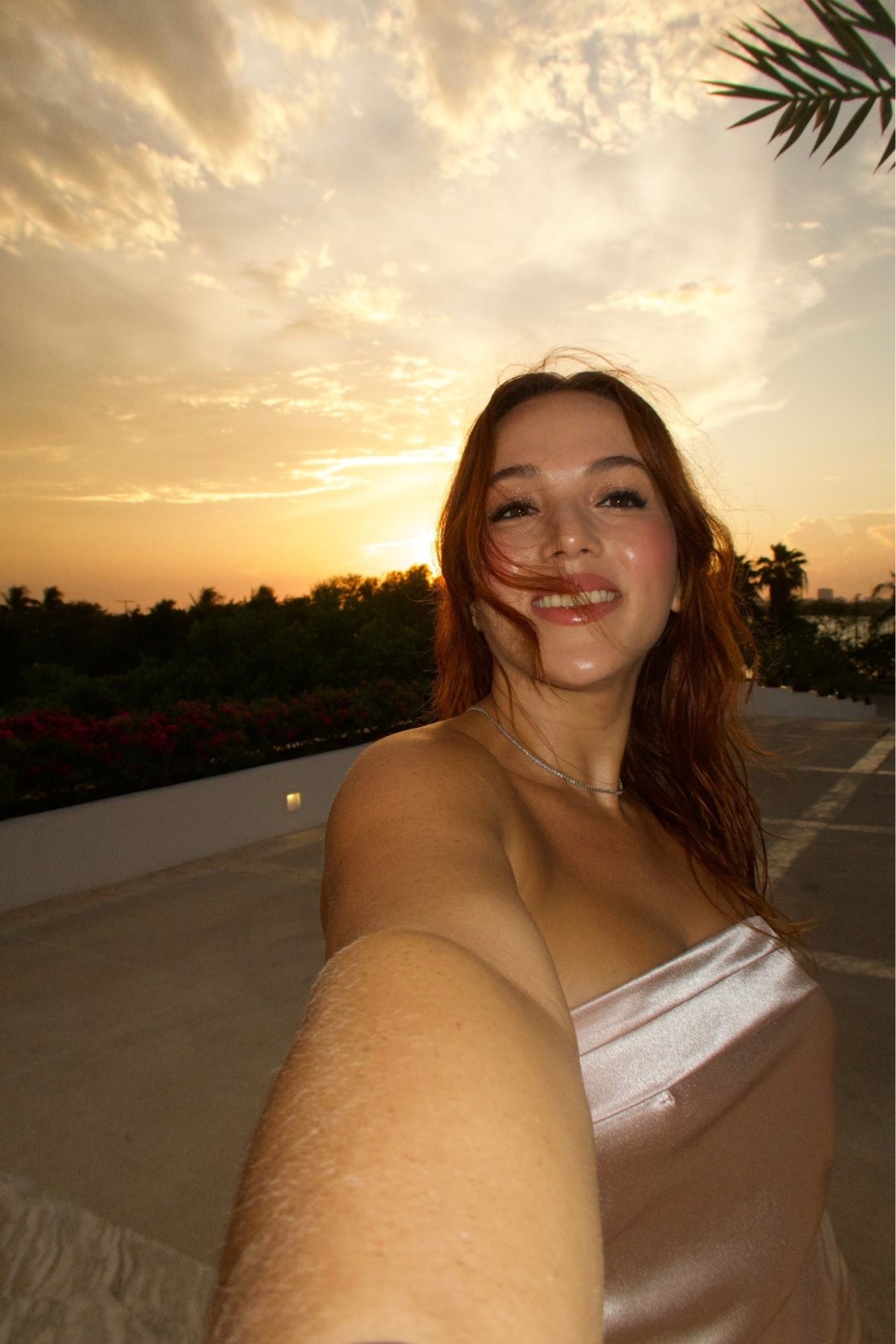 Berly smiling in a golden sunset selfie